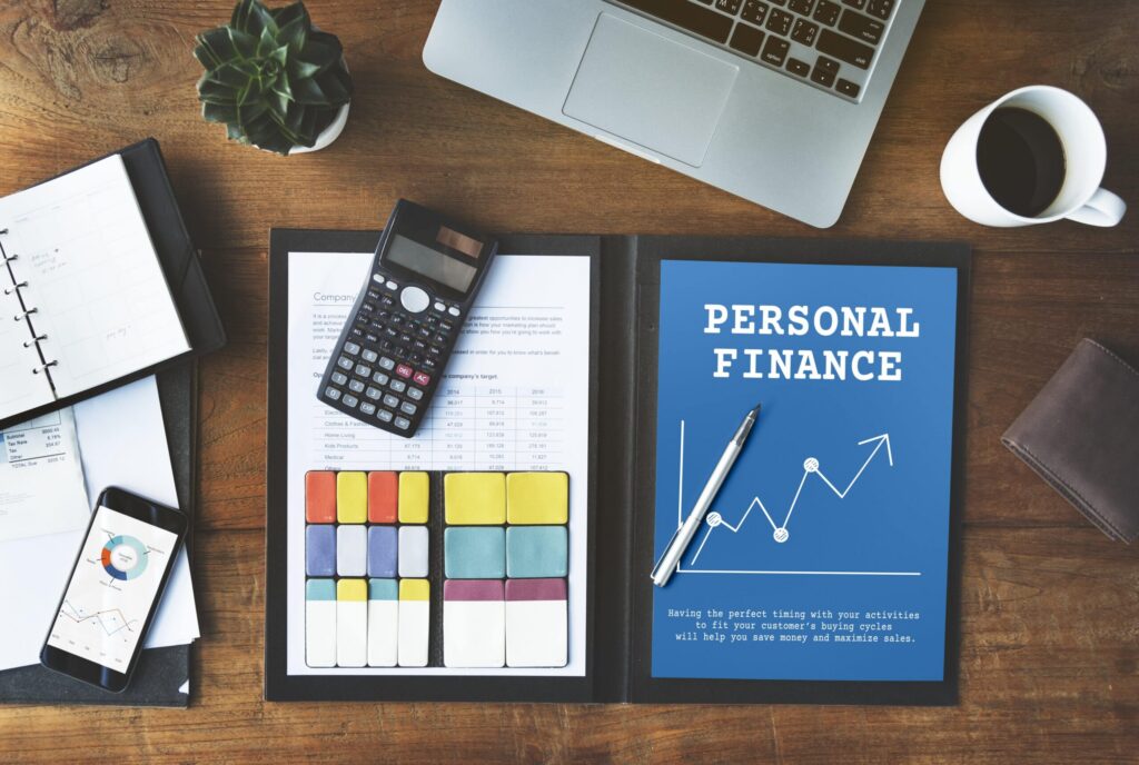Professional finance files, calculator, smartphone, mug and laptop for tax planning person.