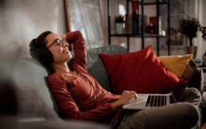 A girl relaxing on the sofa at home thinking about Taxes and Chill: How to Make the IRS Your BFF.