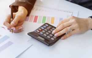 CPA is calculating tax with the use of a calculator.