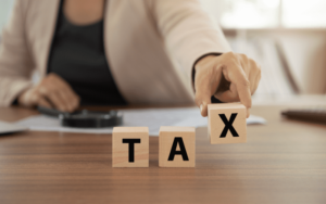 Tax is written on three square blocks.