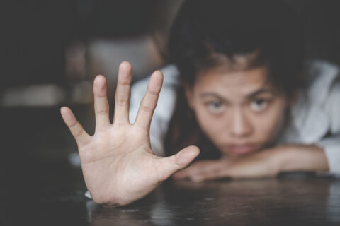 Child reaching out for help, representing child protection, safety, community support, and access to care and social services.